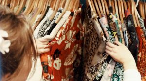 Person browsing through clothes in a shop